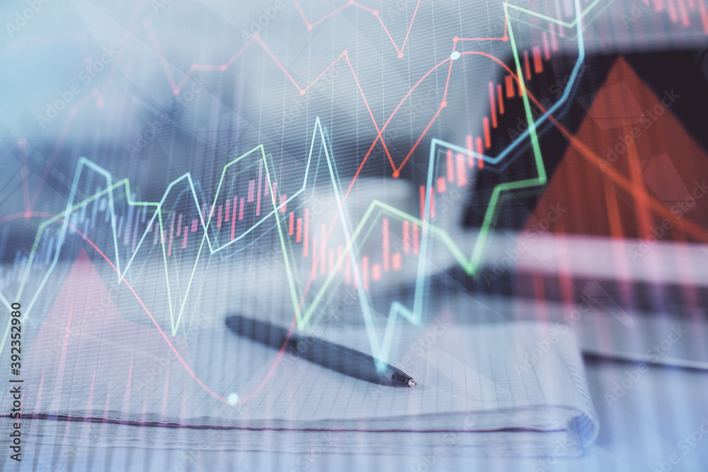 Double exposure of financial graph drawings and desk with open notebook background. Concept of forex market Double exposure of financial graph drawings and desk with open notebook background. Concept of forex market