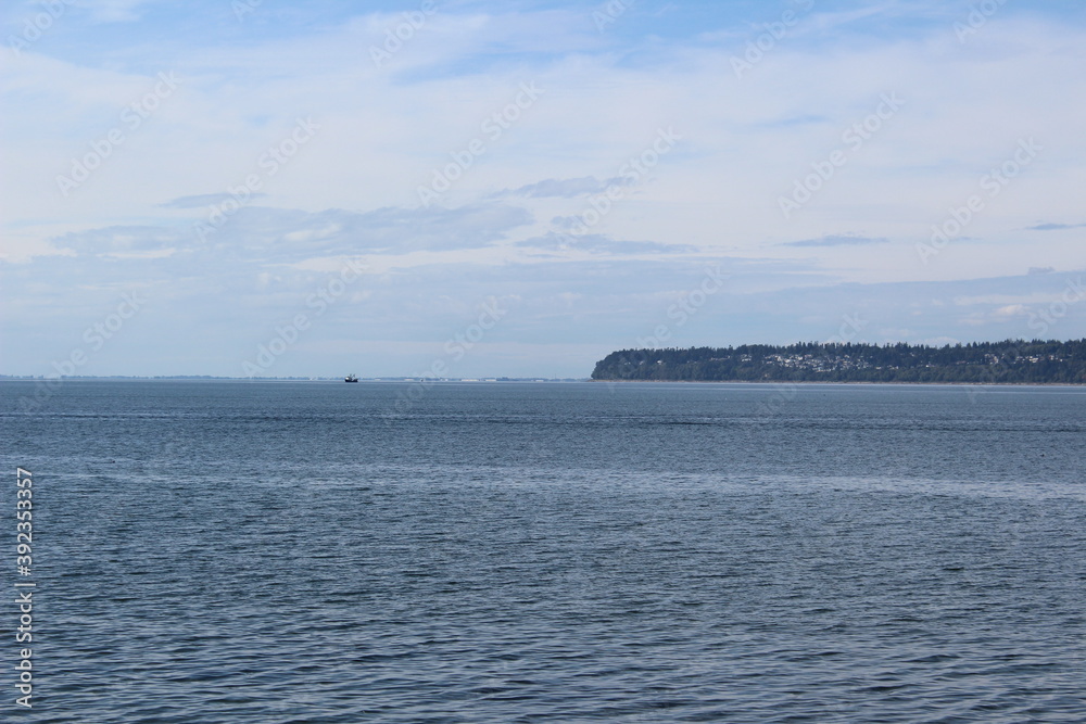 A distance view of White Rock peninsula and Boundary Bay in late summer