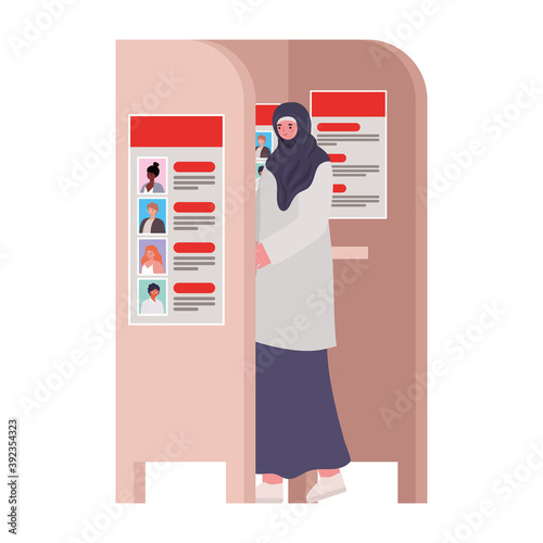 woman voting and dressed in hijab in voting booth