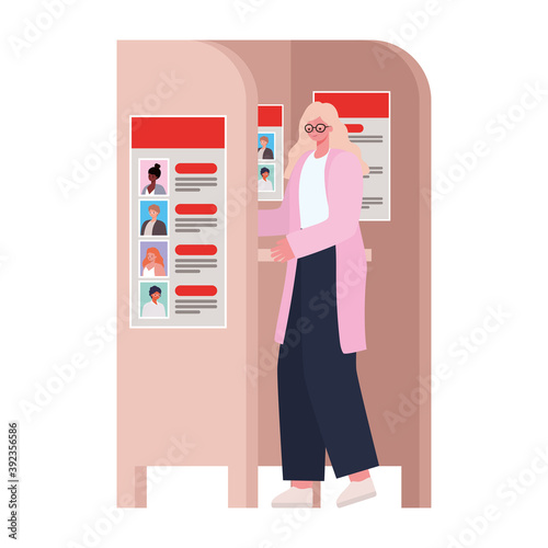 woman voting with yellow hair and a pink coat in voting booth