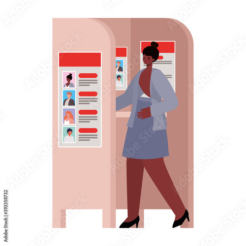 woman voting with black hair and a gray suit in voting booth