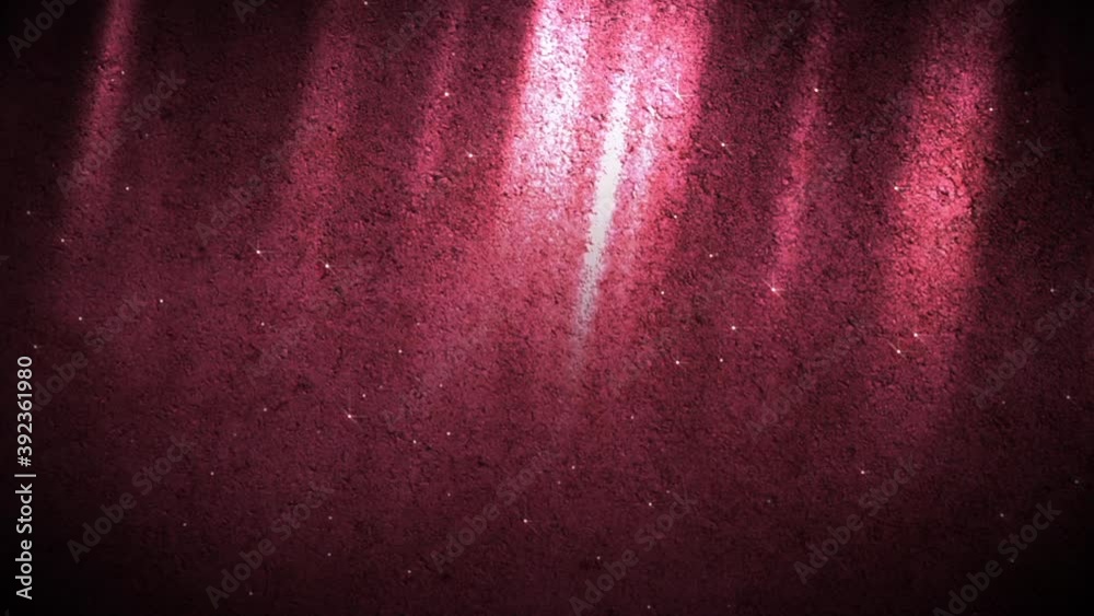 A burgundy colored motion background of a mysterious underground space with rays of red light bouncing off a concrete wall and fairy like dust floating about.