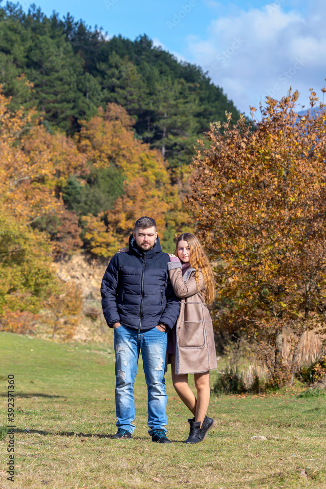 Young married couple on a walk in the autumn park