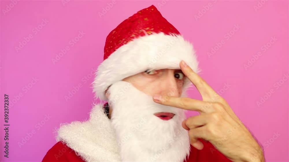 man in santa claus costume having fun dancing on pink background christmas party close up man in santa claus costume having fun dancing on pink background christmas party close up