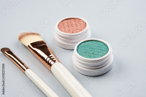 eyeshadow makeup brushes collection professional cosmetics accessories beads on gray background