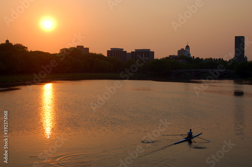 A lone sculler at sunrise on the Charles River, Boston photo