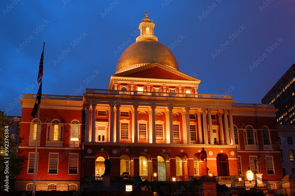 The Massachusetts State House in Boston is illuminated at dusk