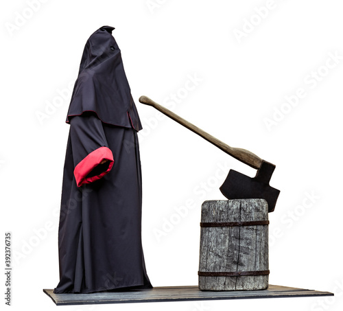 Medieval public executioner at place of separation of the head from the body beheading with an axe on a stump isolated on white.