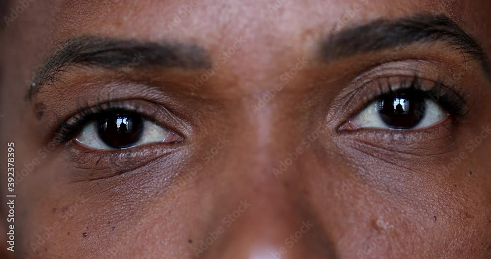 African black woman close-up eyes looking at camera, real people macro