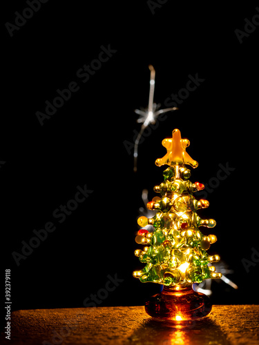 Glass Christmas tree with sparks in background