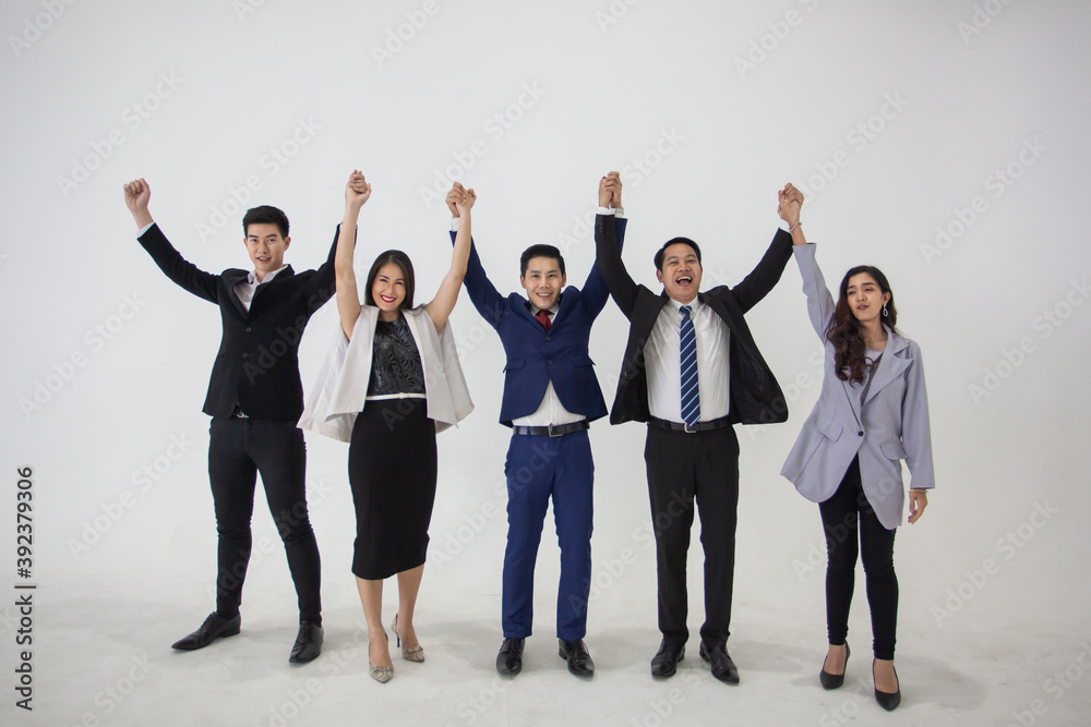 Fototapeta premium Business People Team Success Celebration Concept, Celebrating success. Group of young business people raising their arms. young asian Business people raising their hands up to celebrating success