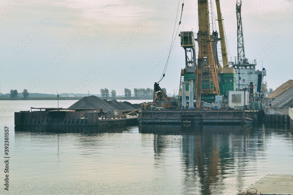 Fototapeta premium Loading and unloading operations in the cargo port, 29 07 2020, Rybinsk, Russia.