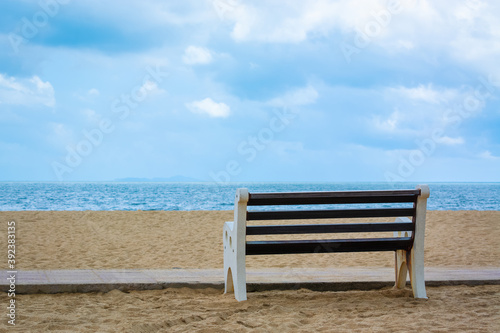 Free bench on the sandy seashore. © Evgenii