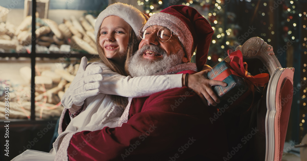 Santa Claus speaking with girl on Christmas eve