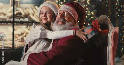 Santa Claus speaking with girl on Christmas eve