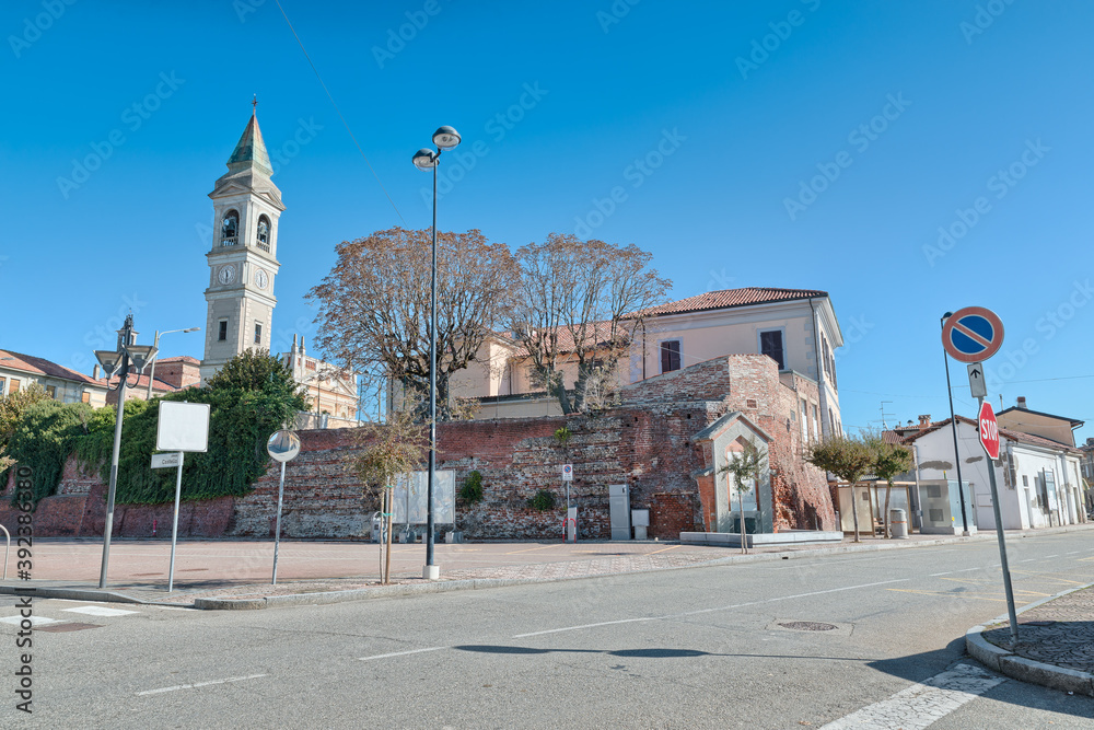 Typical Italian town with the remains of an old castle (12th century) and the parish church (15th century). Town of Casalvolone, piazza Castello, Piedmont region, northern Italy