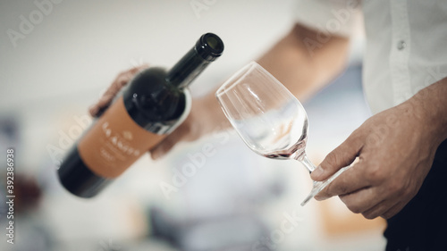 person pouring champagne into a glass