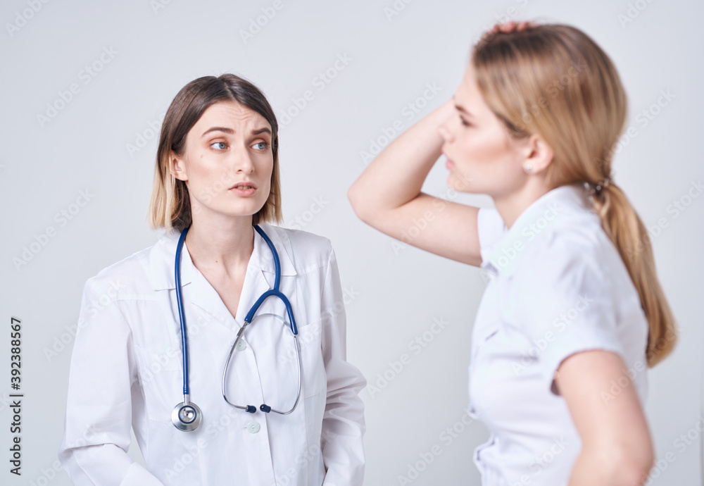 The patient complains to the doctor at will and a blue stethoscope The patient complains to the doctor at will and a blue stethoscope