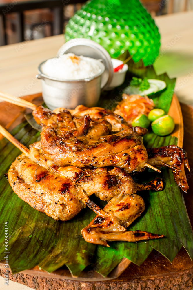 Chicken Inasal, a variant of lechon manok, on a banana leaf on top of