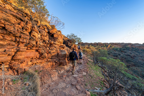 Kings Canyon, Northern Territory, Australia - Vistors hiking in the desert landscape of Kings Canyon, Northern Territory, Australia