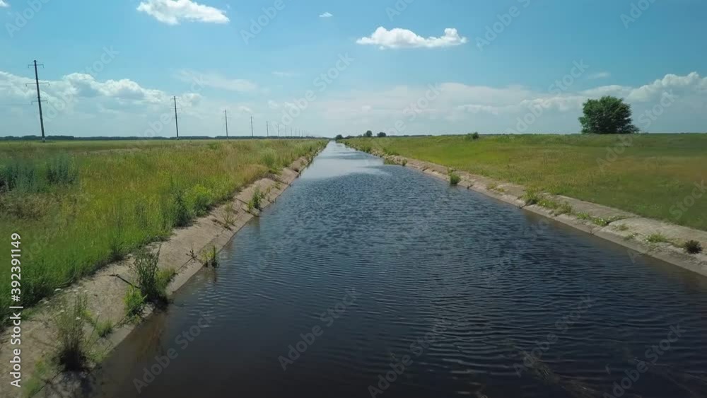 irrigation channel in agricultural field, flying shot over water, aerial view irrigation channel in agricultural field, flying shot over water, aerial view