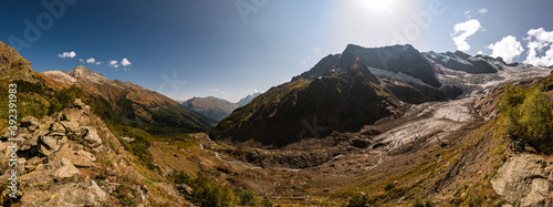 Mountain panoramic view. Alibek glacier and gorge. Autumn in Caucasus mountain. Eco tourism and hiking in mountain, travel destination.