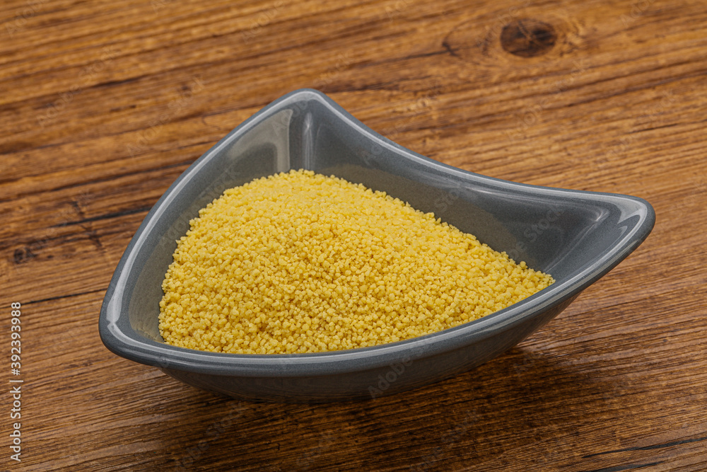 Raw cous cous heap in the bowl Raw cous cous heap in the bowl