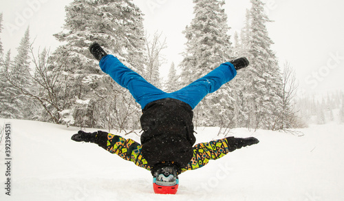 the guy is standing on his head, break in winter,color clothing