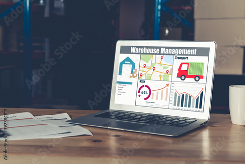 Warehouse management software application in computer for real time monitoring of goods package delivery . PC screen showing smart inventory dashboard for storage and supply chain distribution . photo