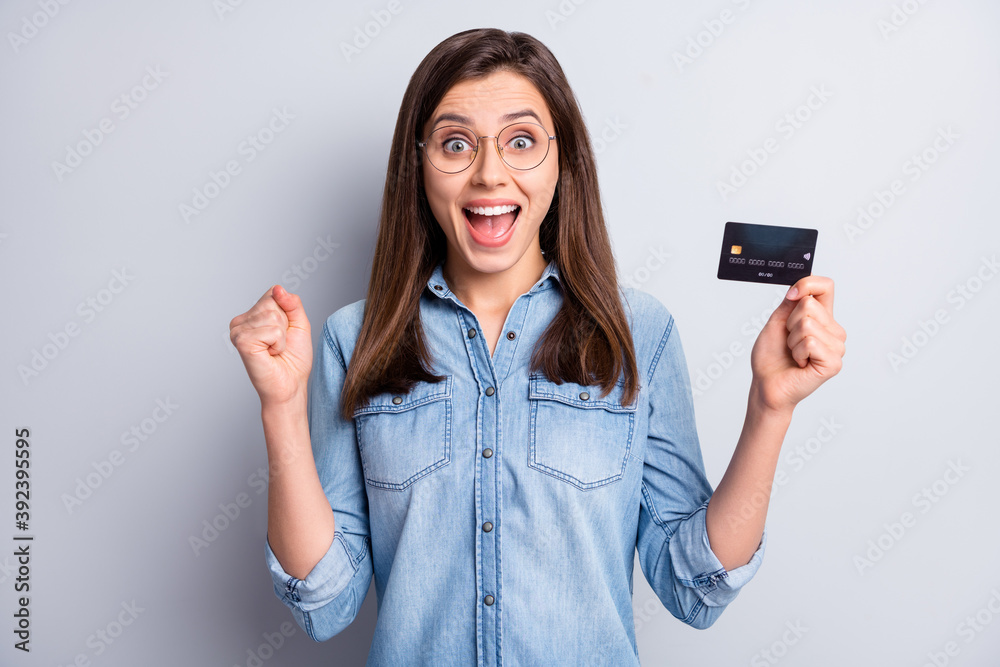 Portrait of attractive impressed person fist up open mouth easy payment isolated on grey color background Portrait of attractive impressed person fist up open mouth easy payment isolated on grey color background