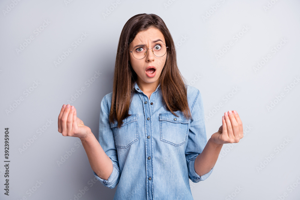 Photo of shocked attractive unhappy woman show ask money gesture salary isolated on grey color background Photo of shocked attractive unhappy woman show ask money gesture salary isolated on grey color background