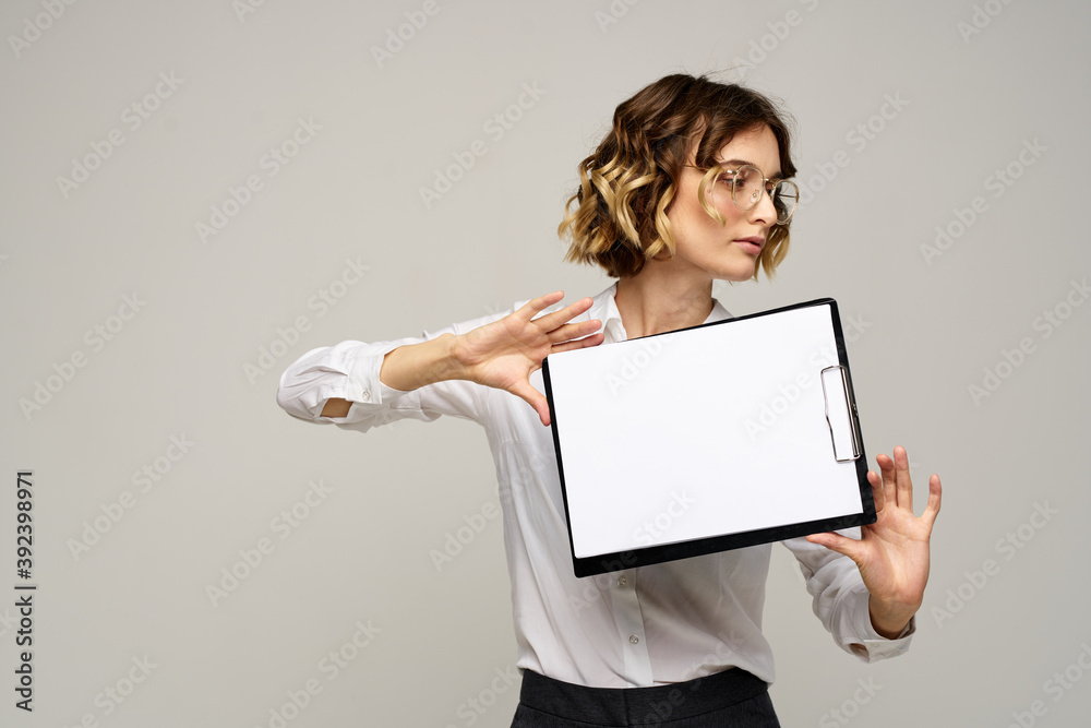 Business woman with folder of documents in hands on gray background cropped view of work