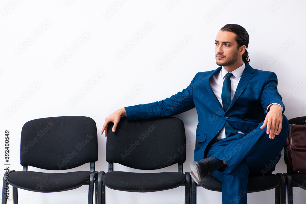 Young businessman waiting for an interview at hall Young businessman waiting for an interview at hall