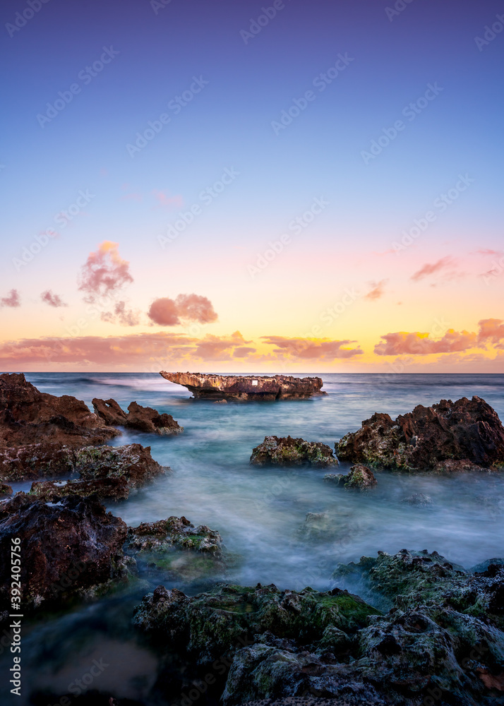 Multi-colored sky with long exposure rocky coastal sunset view
