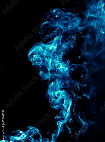 Blue smoke isolated on black background. © schankz