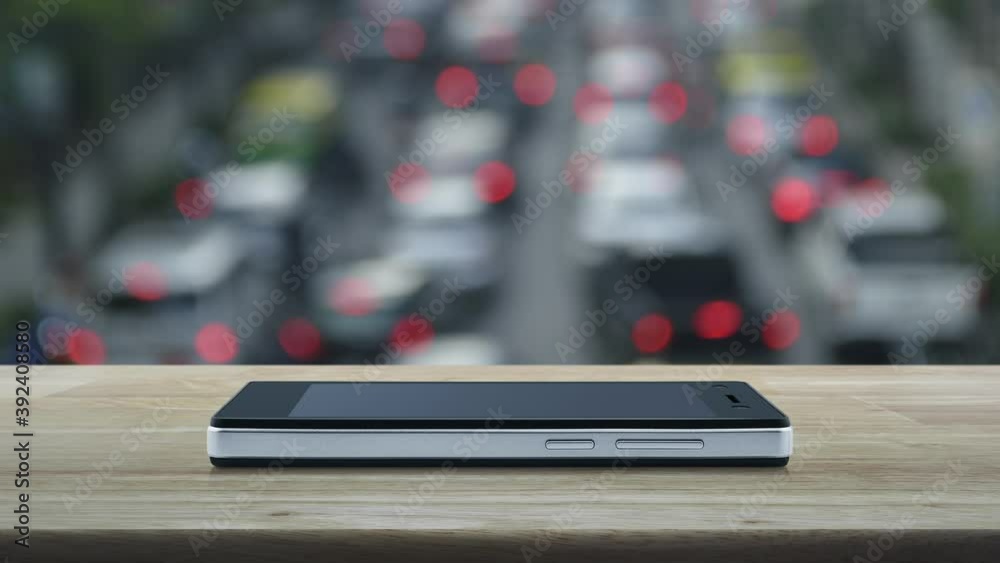 Bus flat icon on modern smart mobile phone screen on wooden table over blur of rush hour with cars and road in city, Business transportation online service concept Bus flat icon on modern smart mobile phone screen on wooden table over blur of rush hour with cars and road in city, Business transportation online service concept