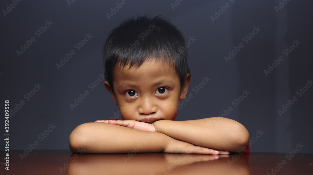 Asian boy portrait with depressing facial expression Asian boy portrait with depressing facial expression