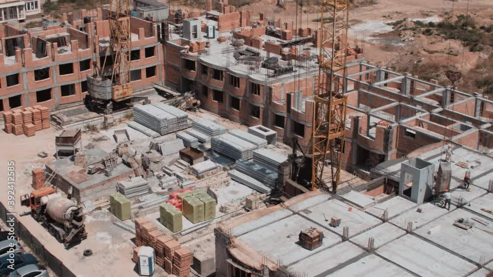 Aerial view on a construction site of the red bricks building Aerial view on a construction site of the red bricks building