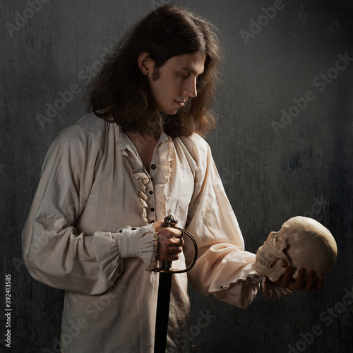 A romantic young man in a medieval costume with a sword says a Shakespearean monologue.