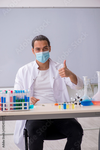 Young male chemist working in the lab