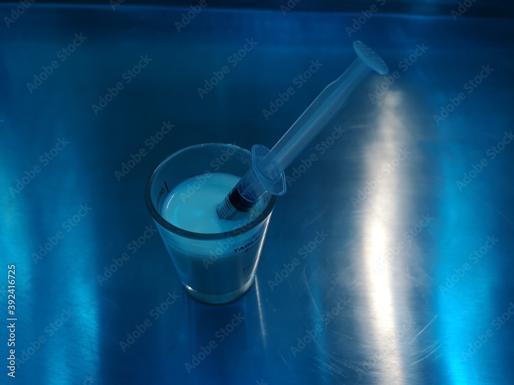 Medicine tube in a medicine glass on the table Medicine tube in a medicine glass on the table