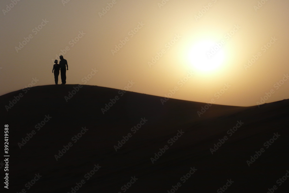 silhouette of a man walking on the beach