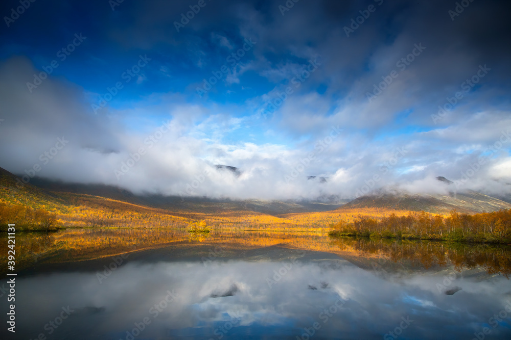 autumn landscape with lake and clouds