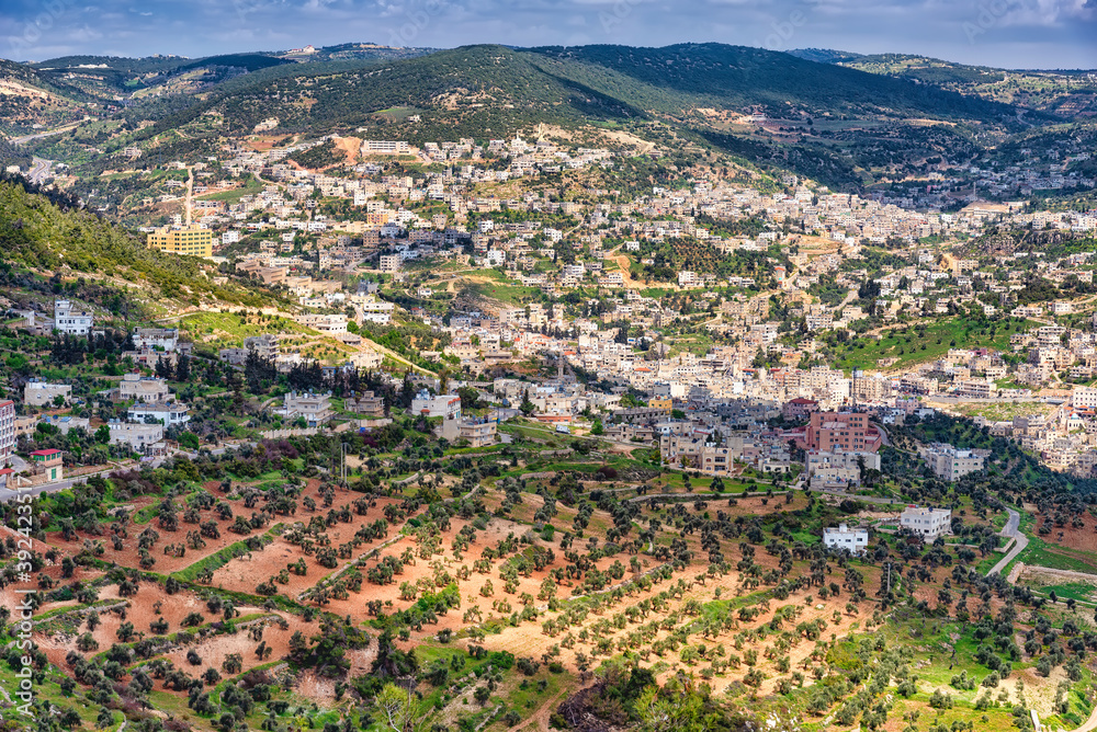 Aerial view of Ajloun town from Rabad castle, Jordan. Ajloun is a hilly  town in the north of Jordan famous for its impressive ruins of the  12th-century Ajloun Castle. Stock Photo