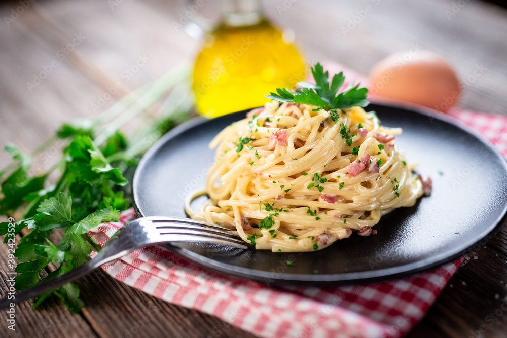 Spaghetti alla carbonara. Pasta with pancetta, egg, parmesan cheese and cream sauce. 