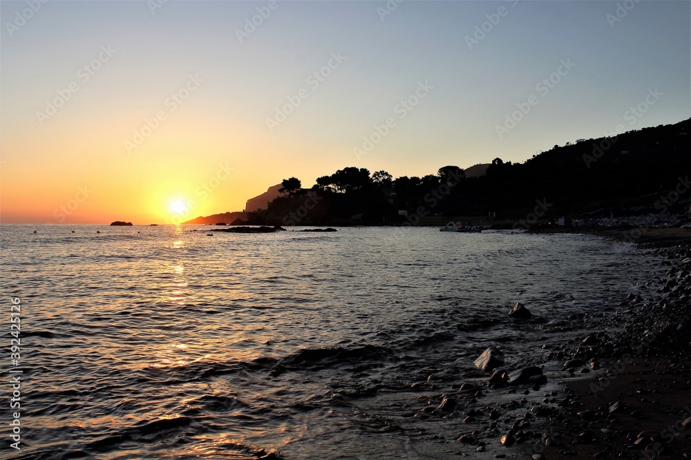 evocative image of sunrise over the sea with the sun rising over the horizon evocative image of sunrise over the sea with the sun rising over the horizon