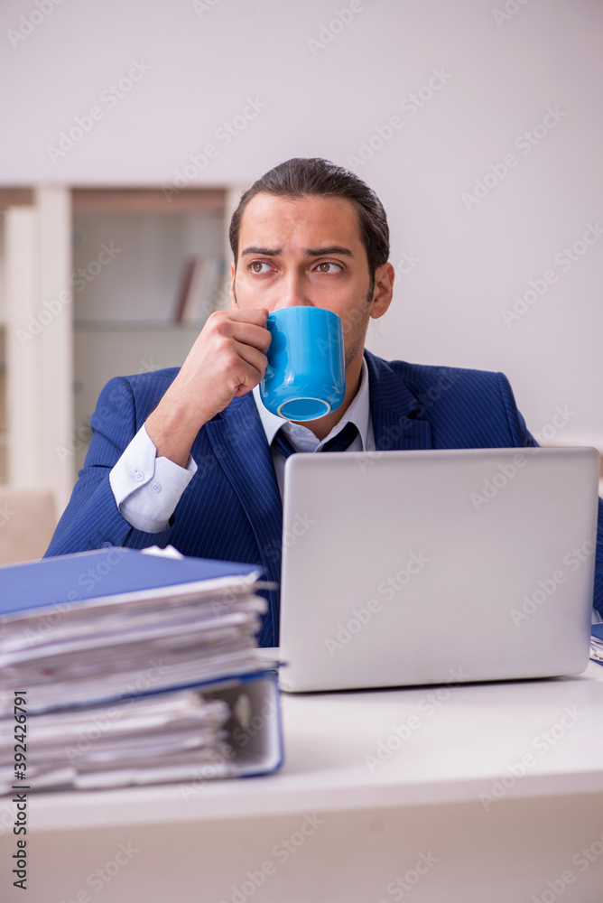 Young male employee working from home in pandemic concept