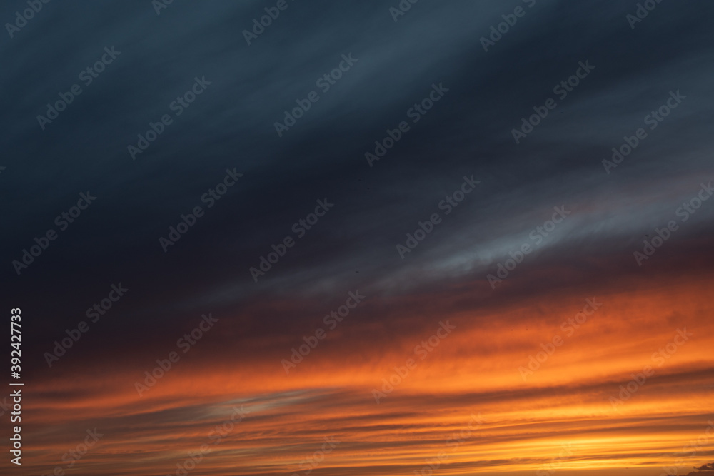 Sunset sky with clouds and orange and blue tones