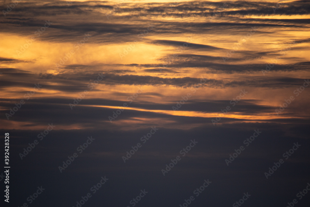 Sunset sky with clouds and orange and blue tones
