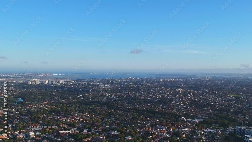 Drone panoramic aerial view of Sydney NSW Australia city Skyline and looking down on all suburban houses and streets Drone panoramic aerial view of Sydney NSW Australia city Skyline and looking down on all suburban houses and streets